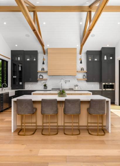Spacious kitchen with a countertop and three bar stools